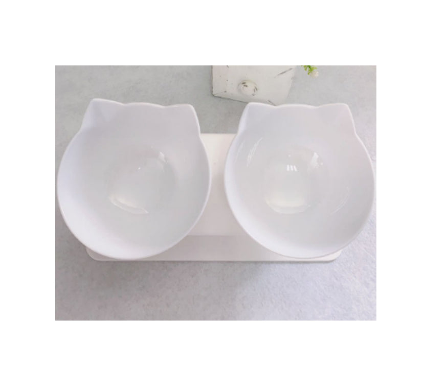 White ceramic cat-shaped double bowl on a light gray surface